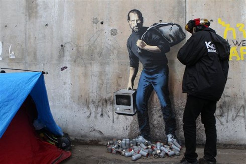 See How Famous Graffiti Artist Banksy Honored Steve Jobs and Syrian Migrants in Latest Work