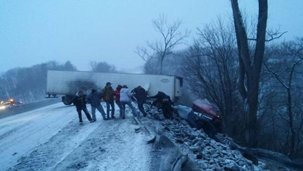 Good Samaritans Form Human Chain to Save Truck Driver Teetering on the Edge of a Hill During Winter Storm
