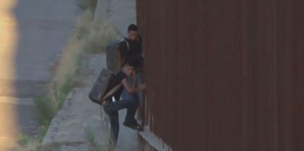Watch As News Cameras Catch Two Alleged Drug Smugglers Easily Scale Border Fence Into Arizona