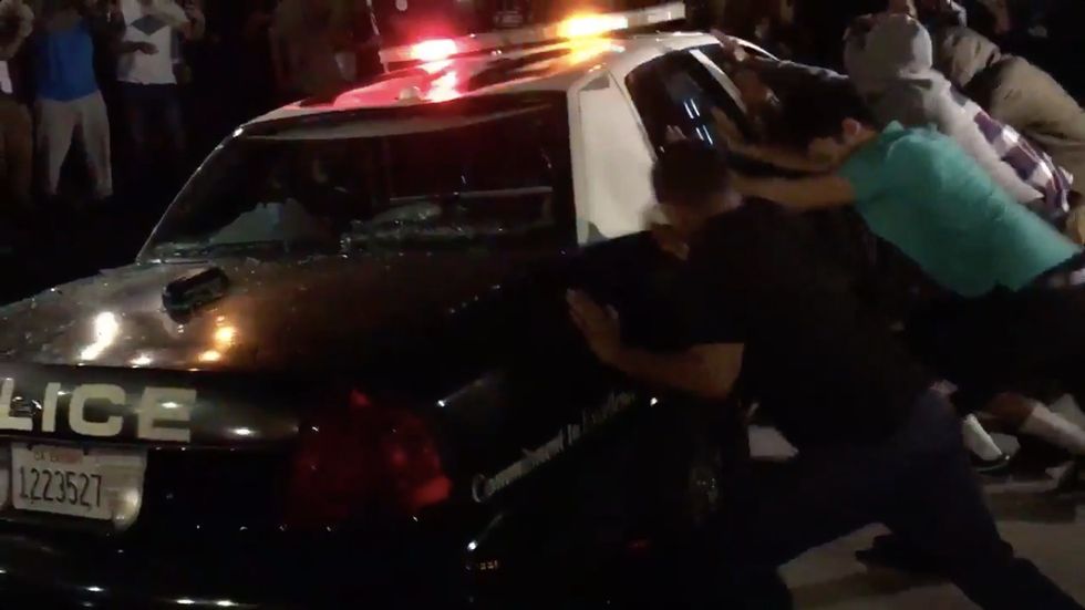 Violent Protesters at Trump Rally in California Smash Police Car, Try to Tip It Over