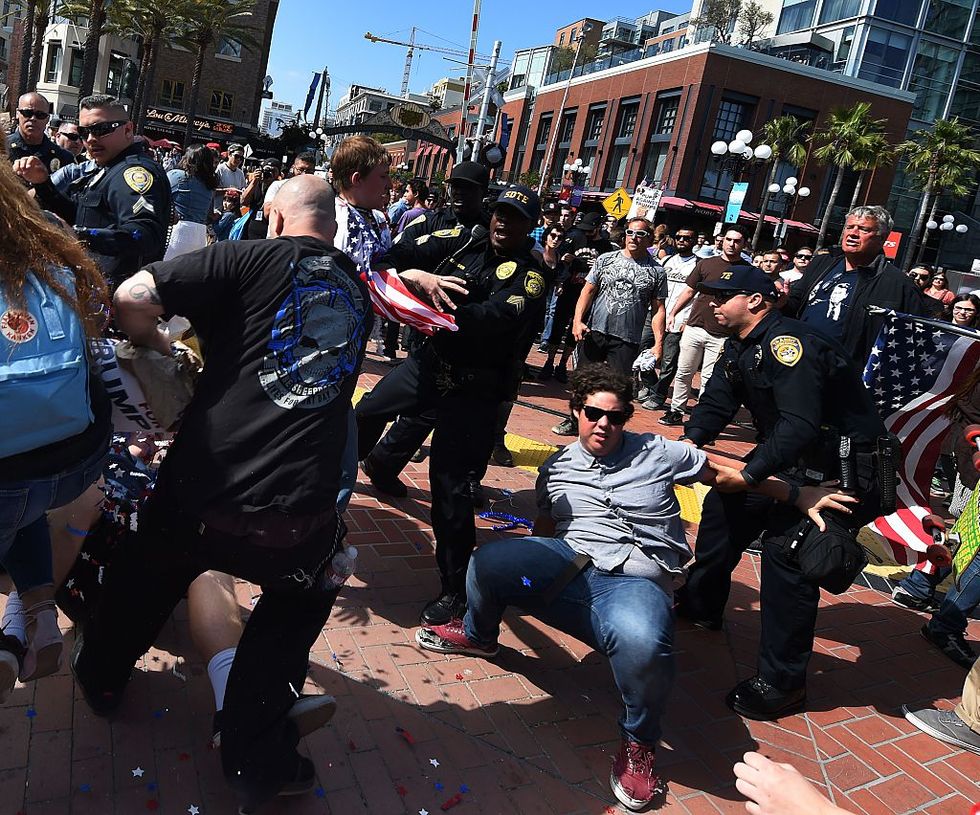 Protesters Clash With Police Outside San Diego Trump Rally, Burn ‘Make America Great Again’ Hats