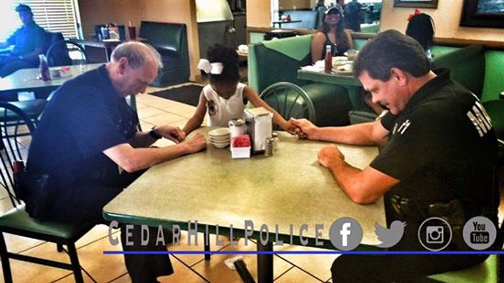 The Reason This 5-Year-Old Girl Joins Hands With Police Officers at a Restaurant Table Just Might Make Your Whole Week