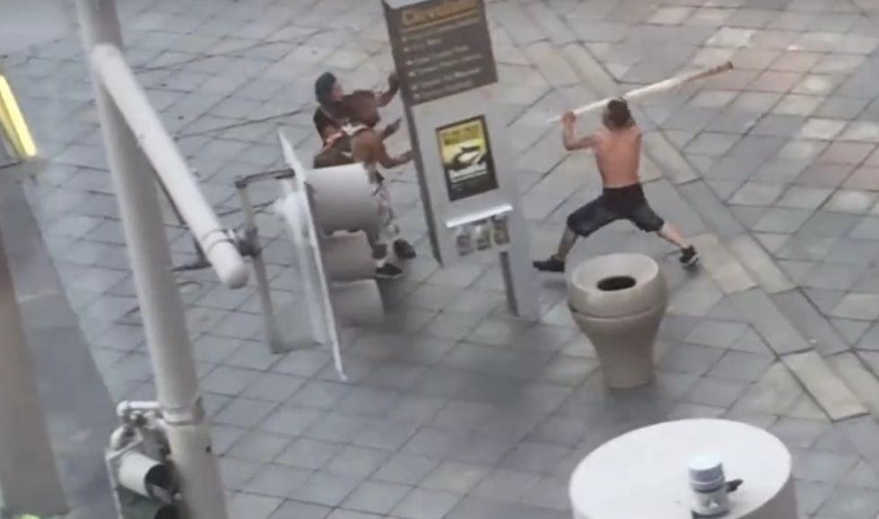 Shirtless Male Caught on Camera Attacking Horrified People in Broad Daylight — and Check Out His Weapon