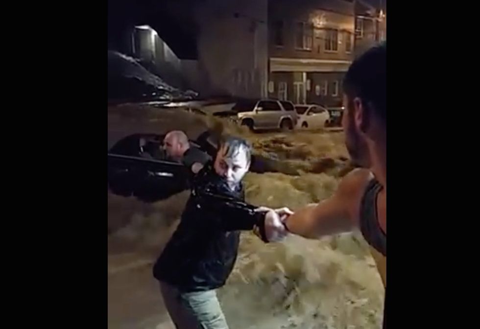 See the Moment Group of Maryland Residents Form Human Chain to Save Woman Trapped in Historic Flooding