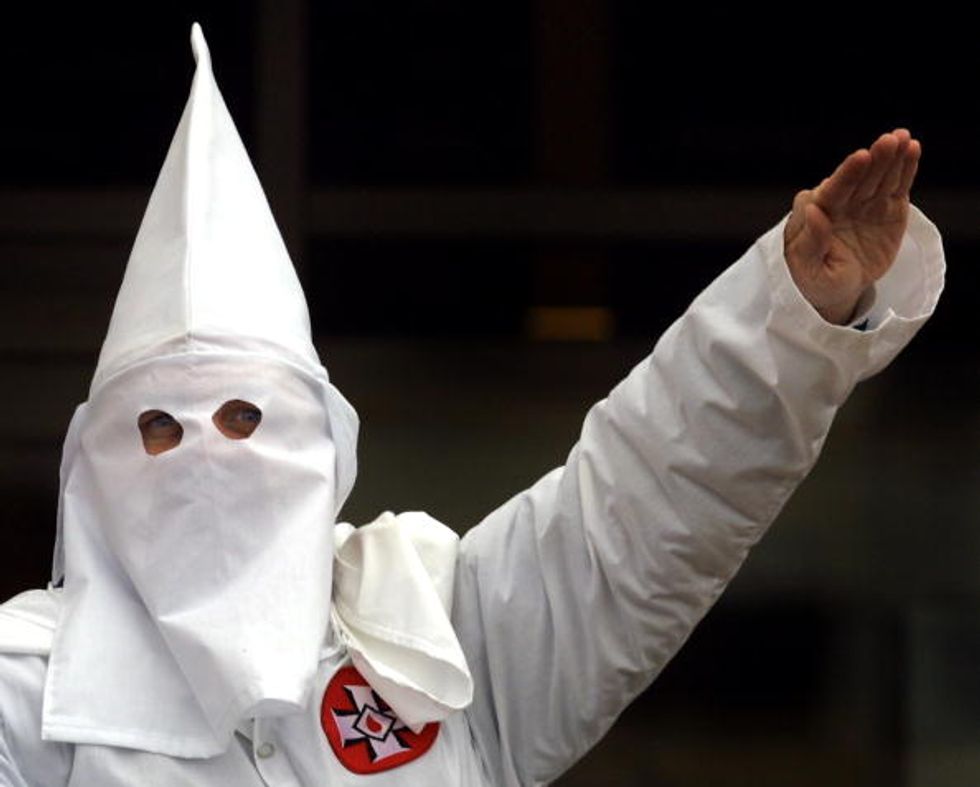 White Retired Teacher Apologizes After Presenting Black Former Colleague With KKK Robe, Confederate Flag