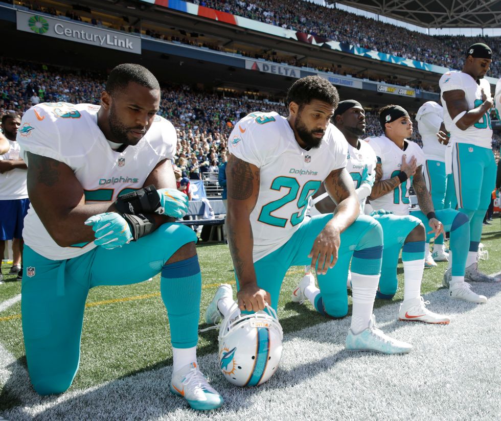 As Dolphins Players Kneel for Anthem, Russell Wilson and the Seahawks Do Something Very Different