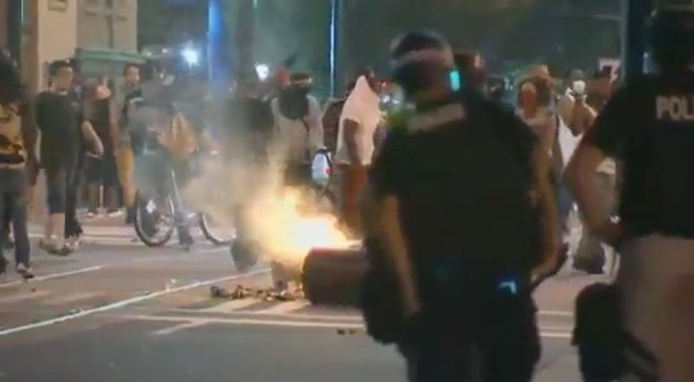 Charlotte protesters allegedly attempt to throw a photographer into a fire
