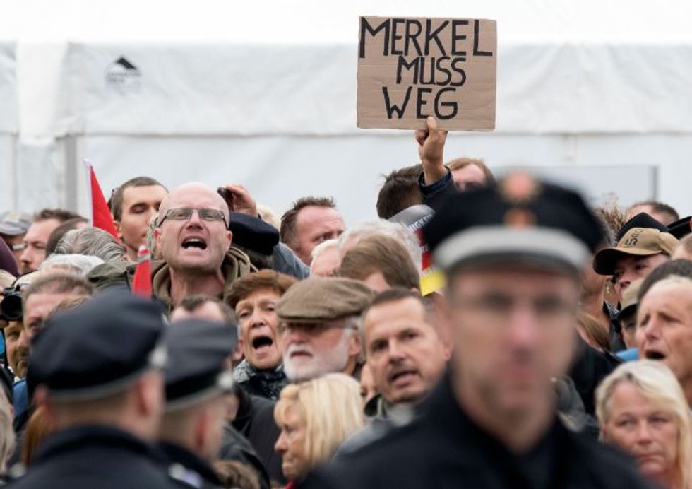 Traitor': Protesters tear into Merkel after ecumenical church service on German unification day