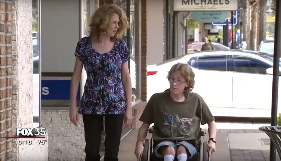 Wheelchair-bound teen with spina bifida notices U.S. flag in approaching parade. His response is going viral.