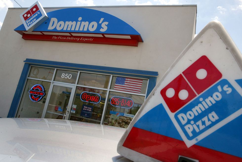 Police release photo showing suspect robbing Domino's Pizza masked as presidential candidate