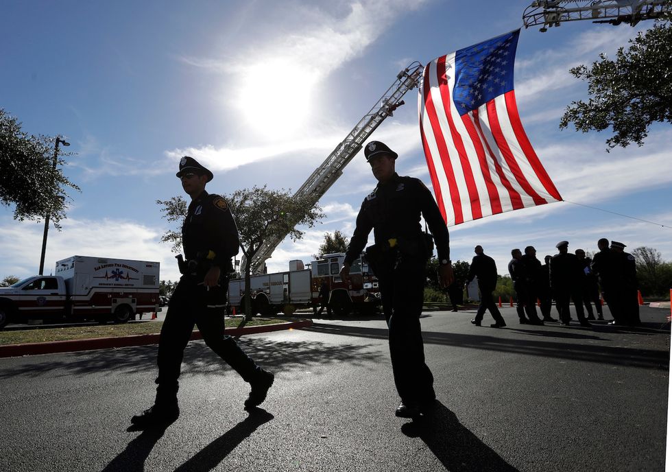 Watch: Hundreds walk in silent march to honor fallen police officer