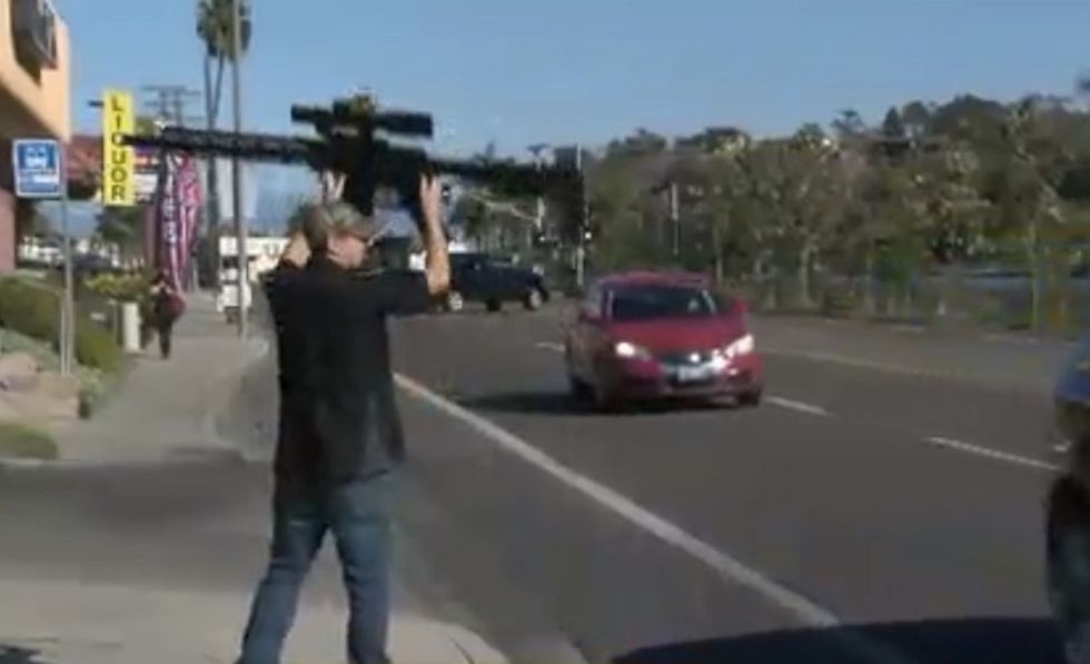 It looks like a machine gun': Gun shop manager triggers outrage over sidewalk promotional stunt