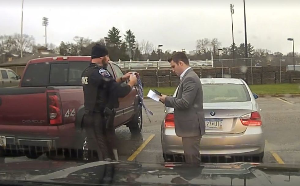 Cop stops speeding student who's late for class — and can't tie necktie. So officer does him a solid.