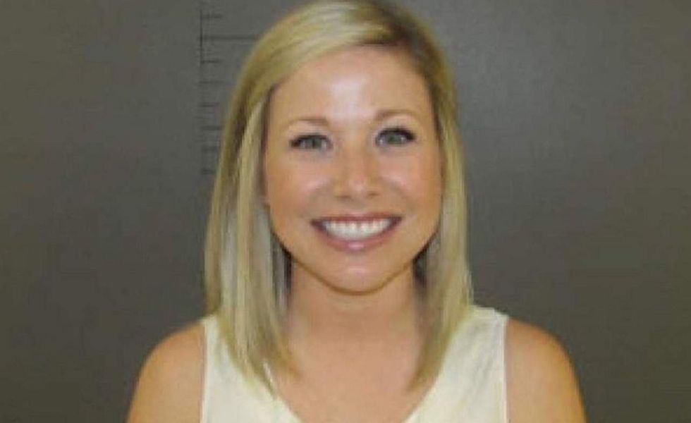 Anatomy teacher accused of 'sexual contact' with student smiles for mugshot. Her lawyer tells why.