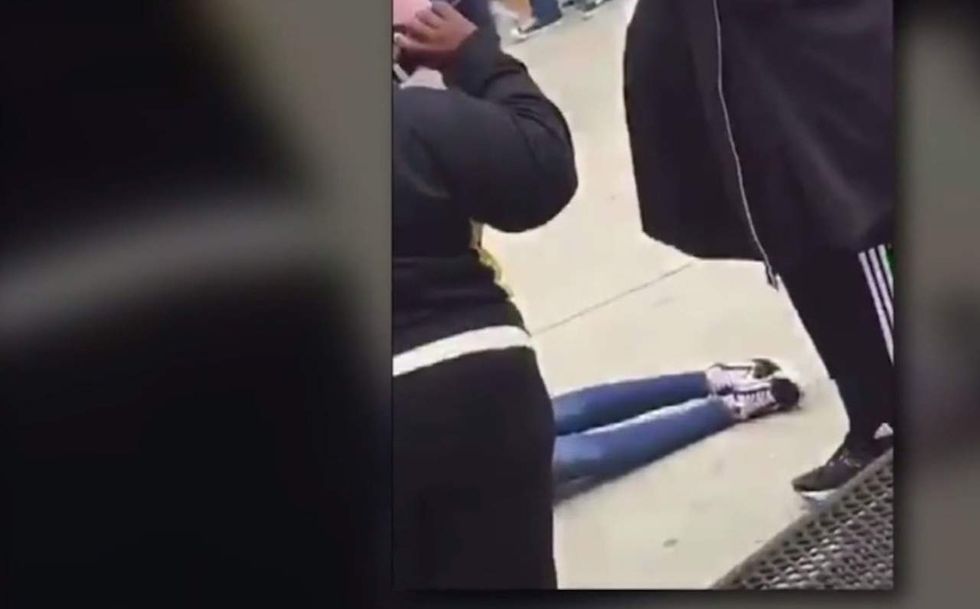 Girl beaten in HS brawl lays on ground with seizure; other students just stand there snapping photos