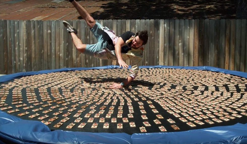 Watch what happens when a guy dives on a trampoline covered with 1,000 mouse traps — in slow motion