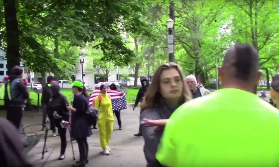 Antifa punk tries blocking big guy wearing 'In God We Trust' shirt at protest — and pays for it
