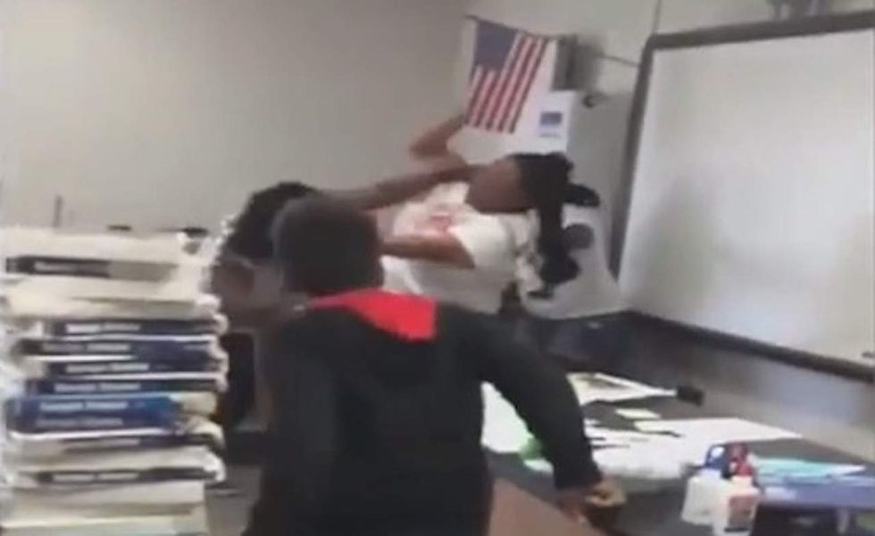 Middle school teacher and her aide caught on video in vicious brawl in front of students