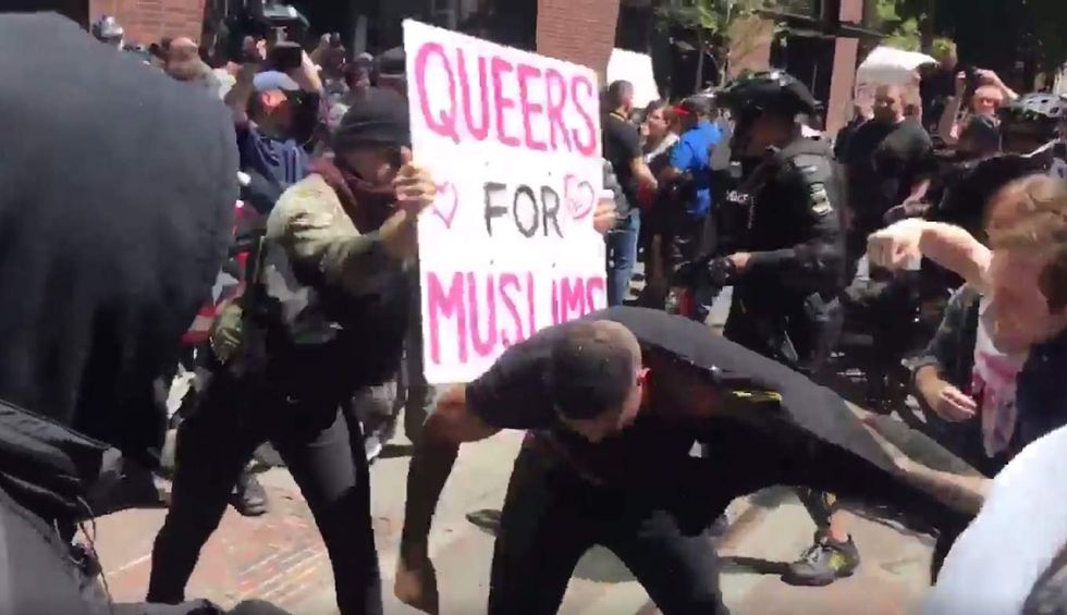 Leftist thugs beat up man at anti-Shariah rally. He's even pummeled with 'Queers for Muslims' sign.