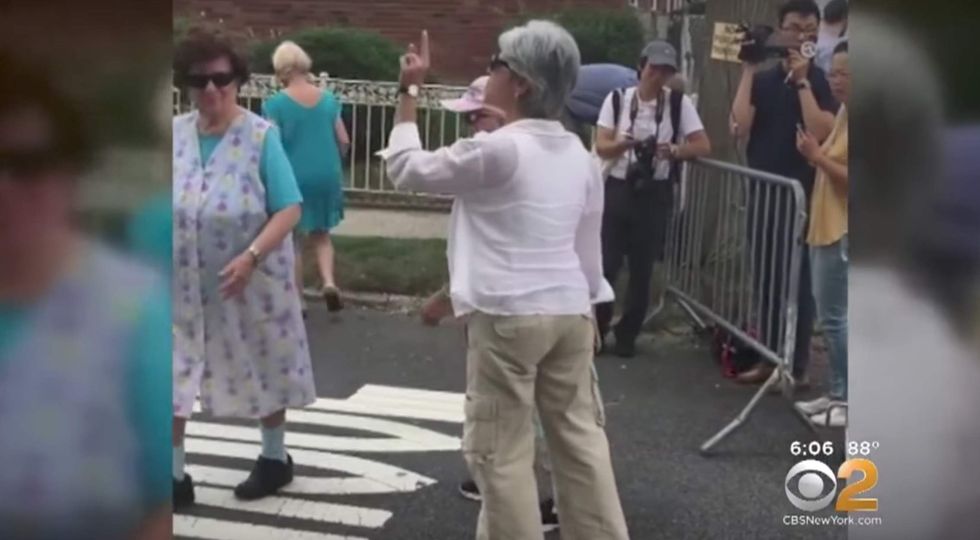 Elderly woman angrily confronts Bill de Blasio for jetting to Germany — so he takes cowards way out