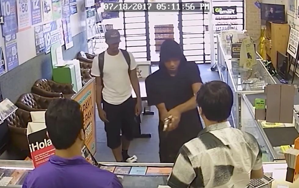Watch: Two armed thugs try to rob a cellphone store, but the owner and his son fight back