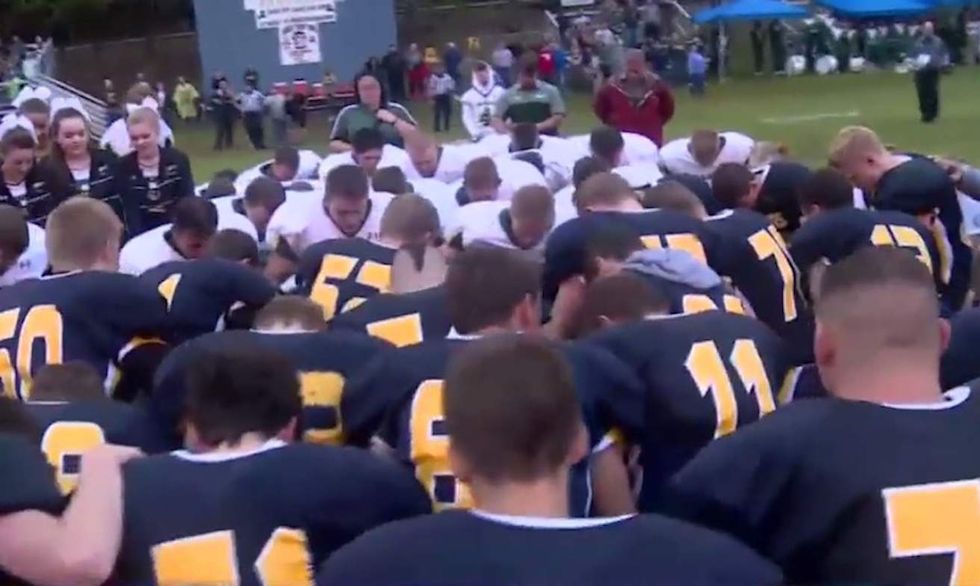 Prayer over loudspeakers banned at HS football games. Watch how players from both teams react.