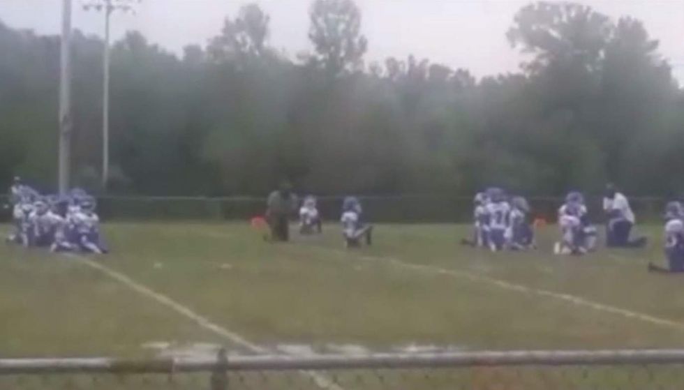 Watch: 8-year-old football players take knee during national anthem