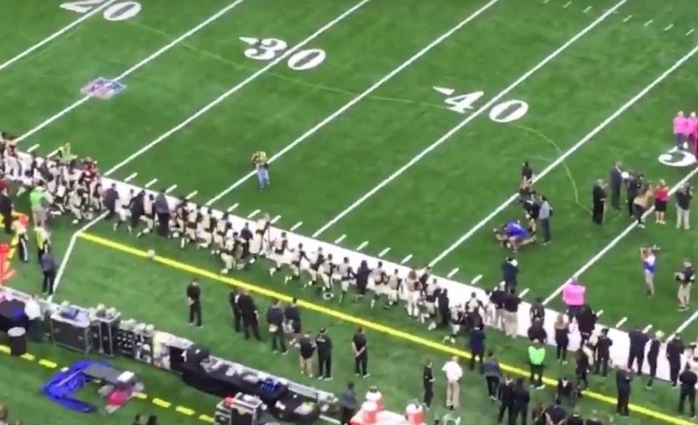 Saints players stay on knee during moment of silence for fallen police officer—and fans aren't happy