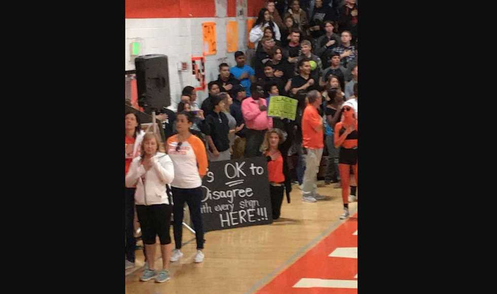 HS chemistry teacher suspended after she kneels at school assembly with 'Black Lives Matter' sign