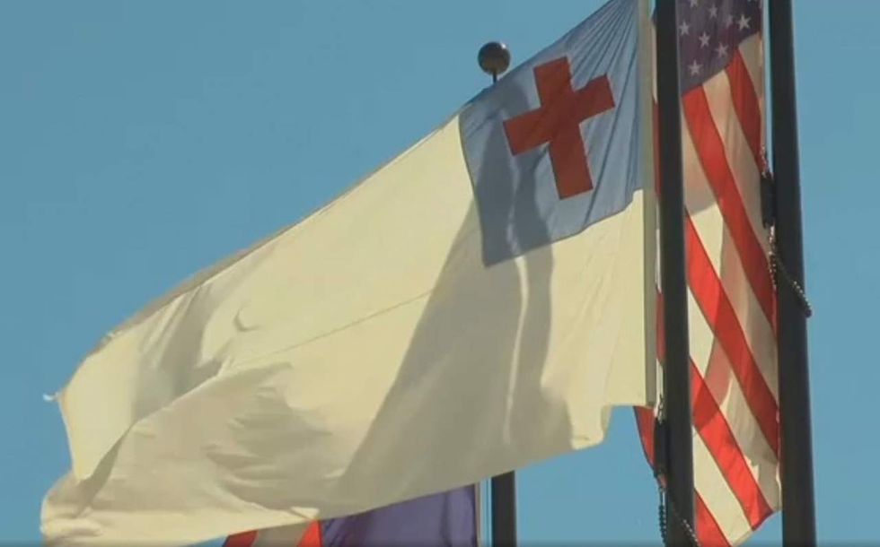 Atheists demand public school take down Christian flag. Then students respond with defiant action.