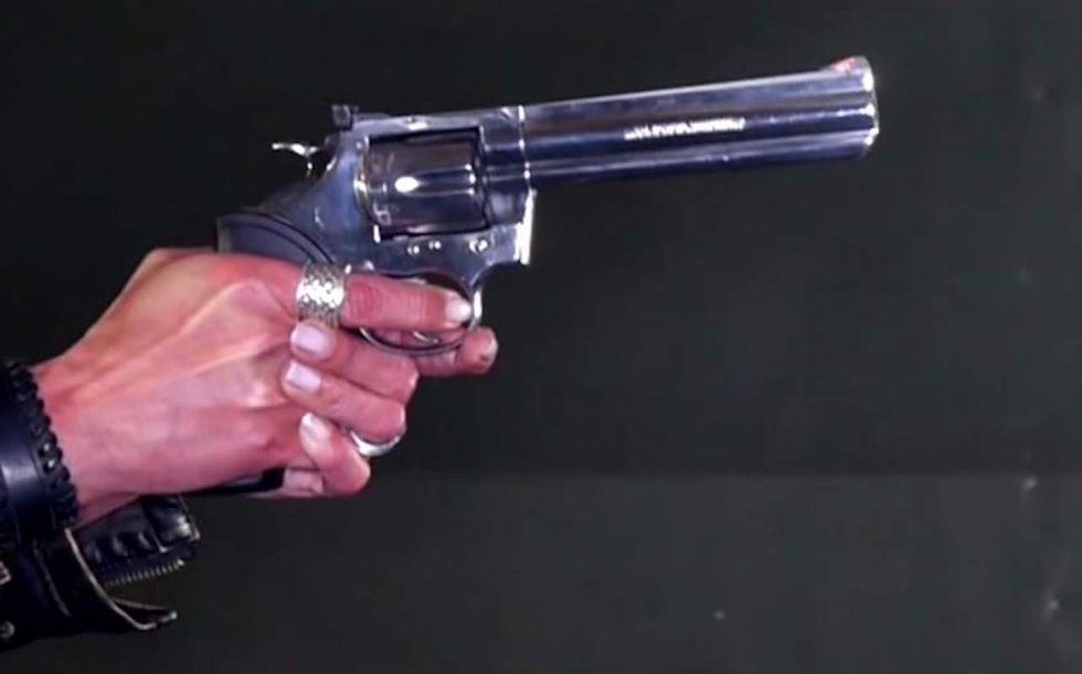 Suspected burglars wearing hoods gather at woman's front door. But she greets them carrying a gun.