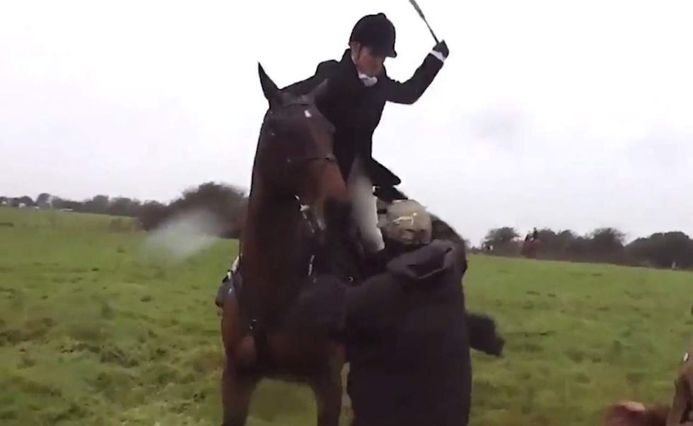Woman on horseback whips the hell out of hunting 'saboteur' who grabs animal's reins in angry clash