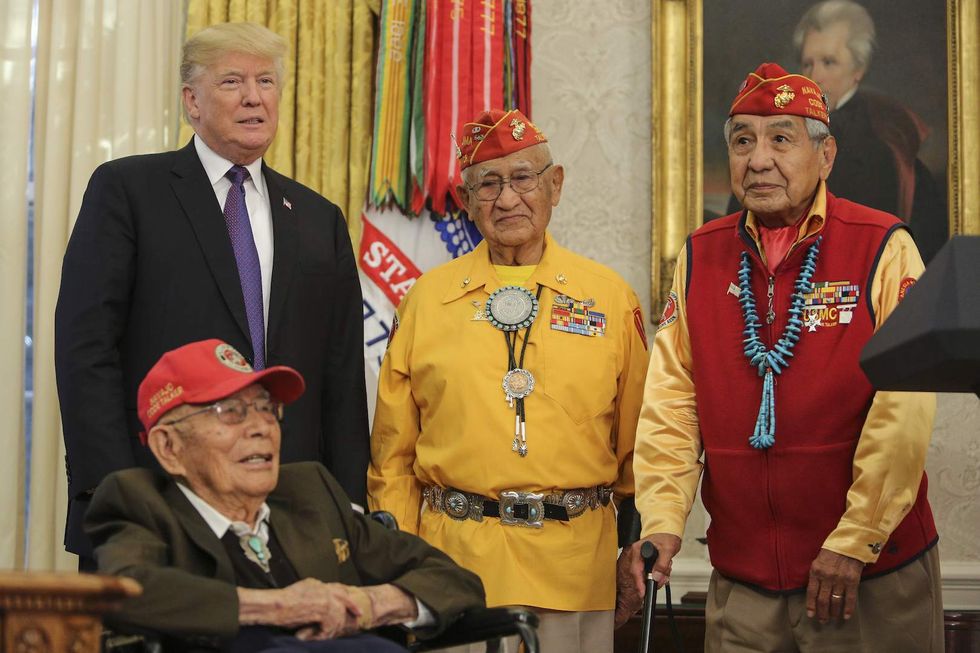 Warren accuses Trump of using racial slur while honoring Native American veterans