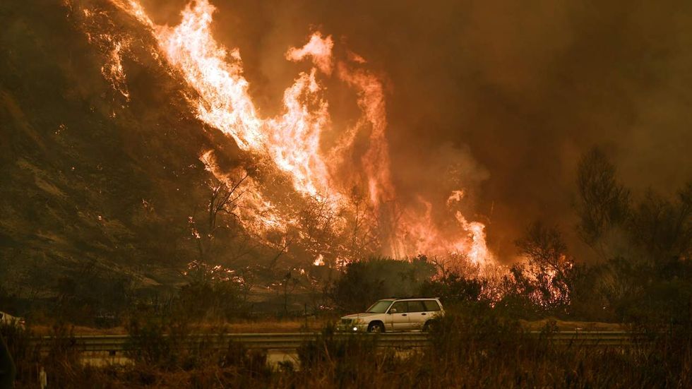 Multimillion-dollar Bel-Air homes burn, busy freeway closes in latest LA-area wildfire