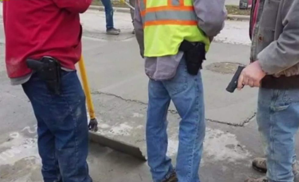 Photo shows construction workers carrying guns on the job — and they've just learned their fate