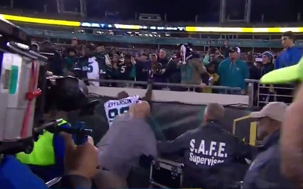 NFL player tries climbing into stands when fans throw drinks at him — and ESPN pundit backs him up