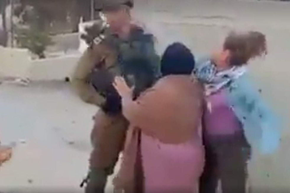 Israeli soldier slapped in face, kicked by Palestinian teen girl. His restraint has people talking.