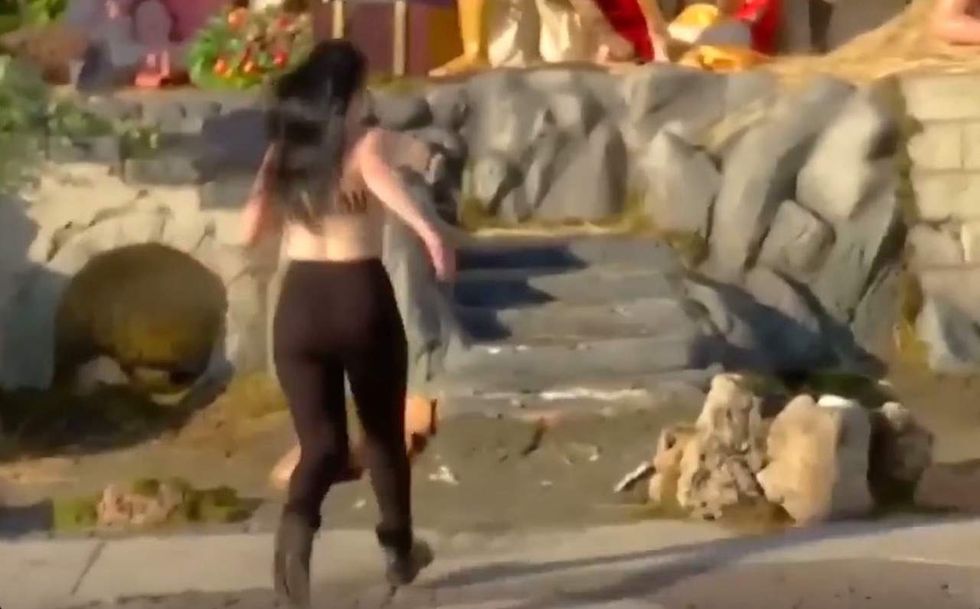 Topless activist grabs Jesus from Vatican Nativity scene, shouts 'God is woman