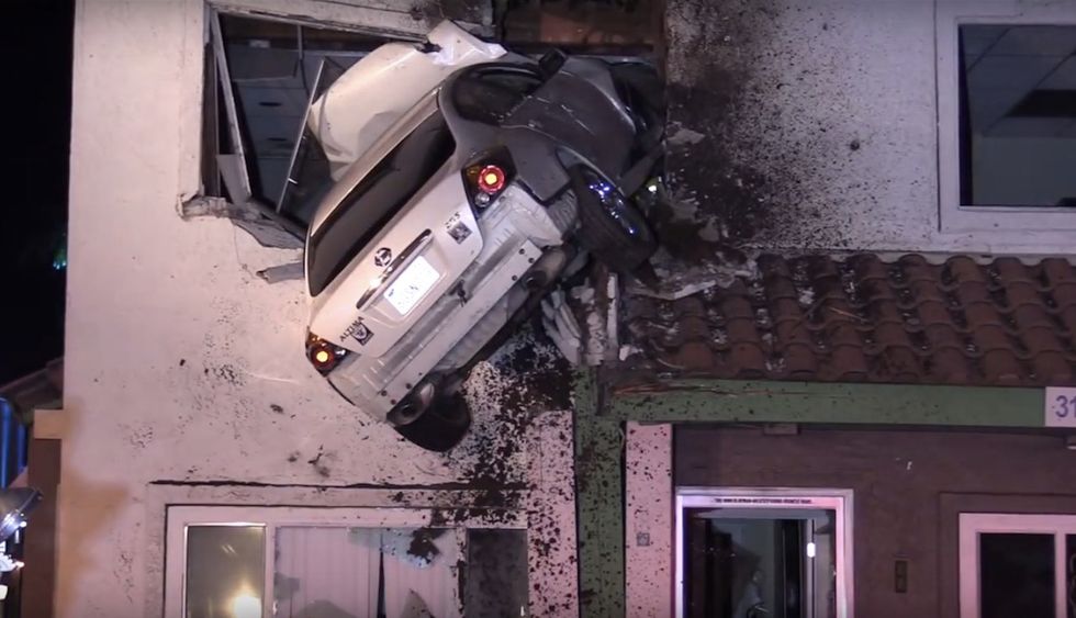 Speeding car hits median and takes flight — big time. Check out where it ends up.