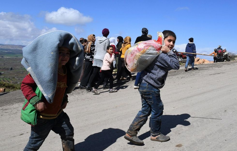 Tens of thousands flee Turkish attack on Kurdish town in Syria
