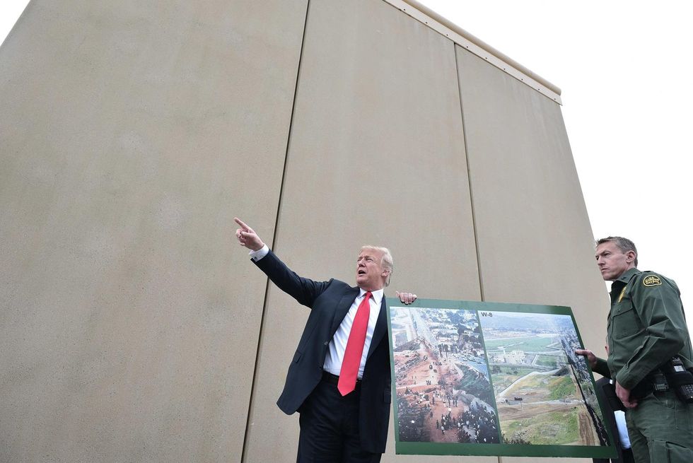 Trump threatens to veto massive spending bill over border wall and DACA; could trigger shutdown