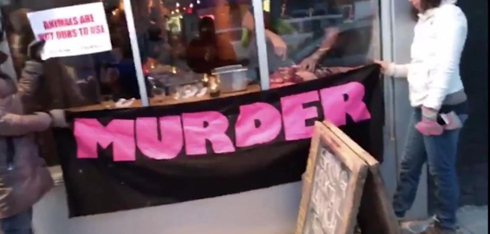 Vegans protesting against restaurant are horrified at owner's revenge - and there's video