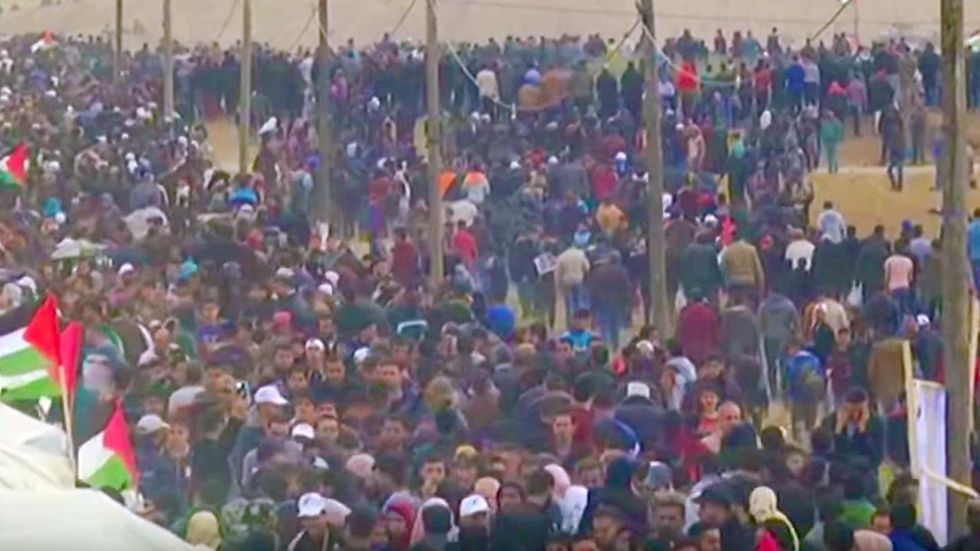 Tens of thousands of Palestinians storm Israeli border fence in violent land protest
