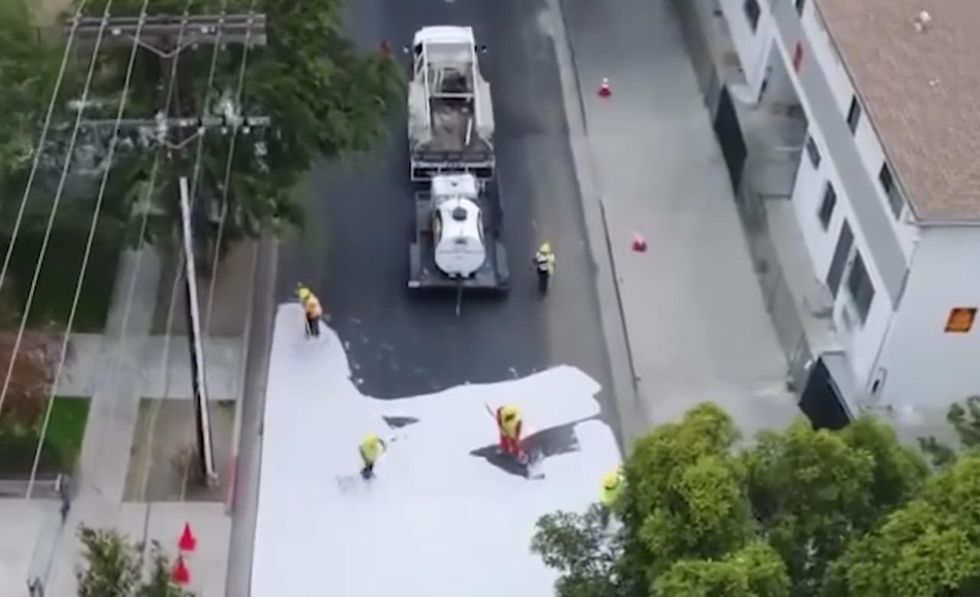 City crews are painting Los Angeles streets a lighter color to reduce climate change