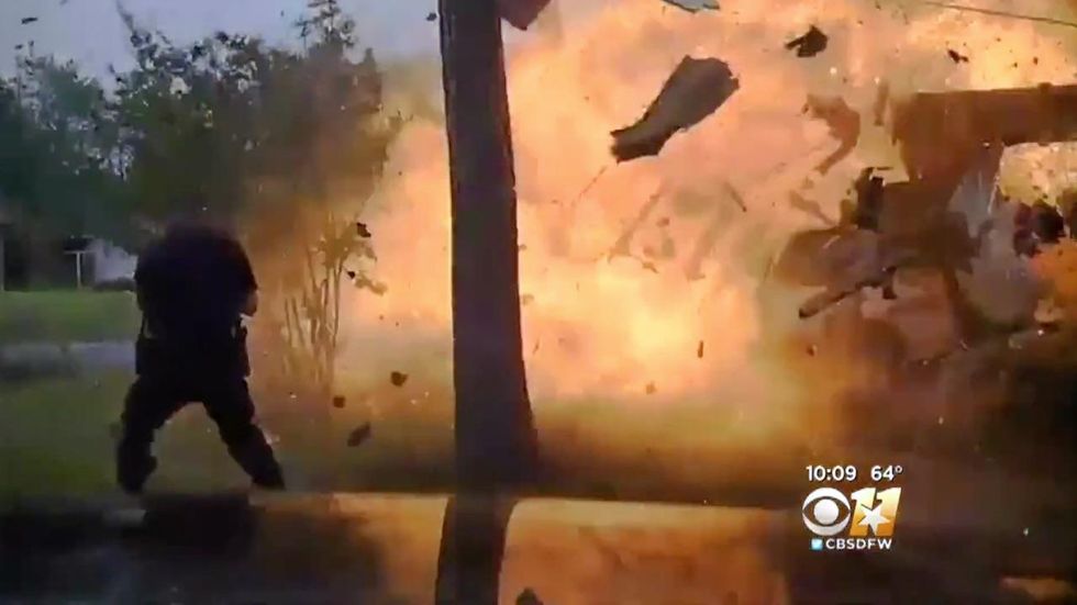 Watch: Officers rush inside home after pickup crashes into it and causes it to explode