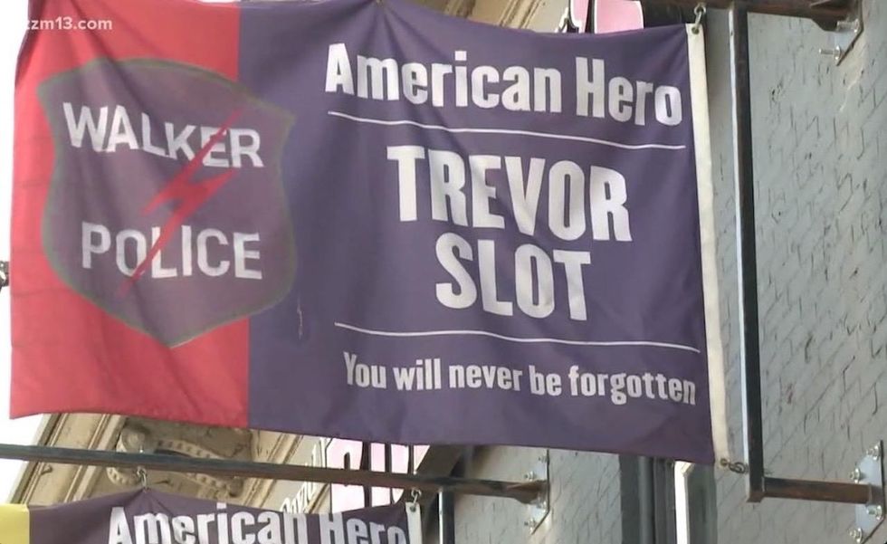 Restaurant flags honor fallen officers. City says they violate code. Owner issues defiant response.