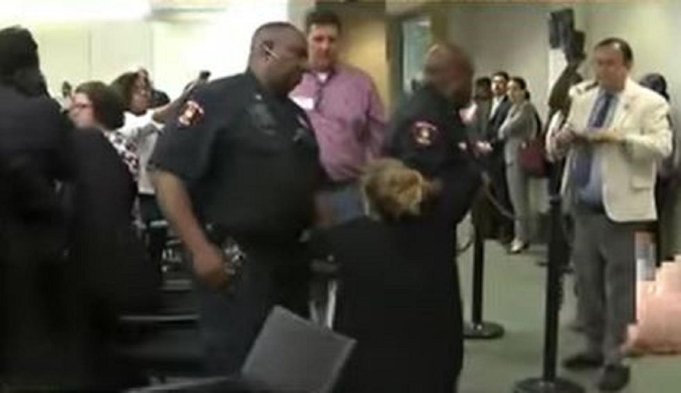 Police arrest parents, dragging one out, in school board meeting proposing charter schools