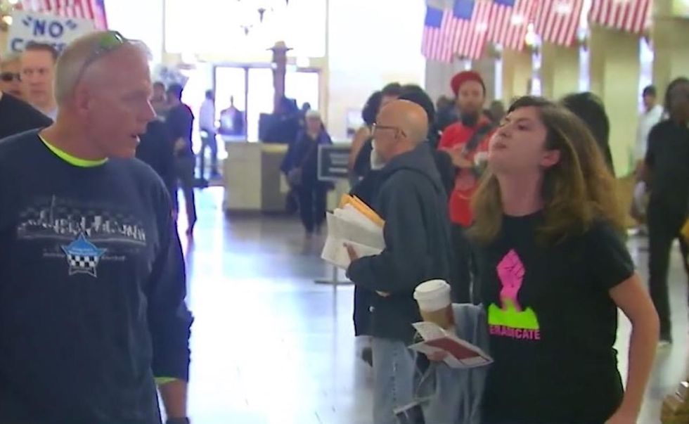 VIDEO: Unhinged woman spits on police officer at protest; cops offer reward in effort to find her