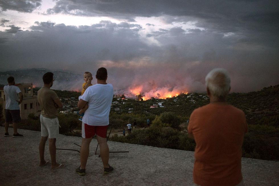 At least 60 killed in Greece by wildfires in what official calls a 'biblical disaster