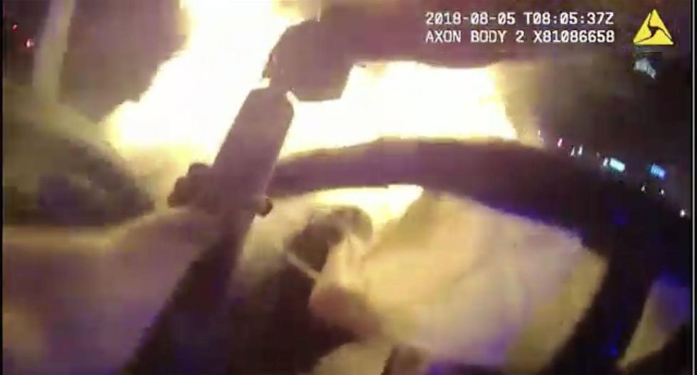 Watch: Incredible bodycam footage captures the moment hero cop rescues a man from burning car